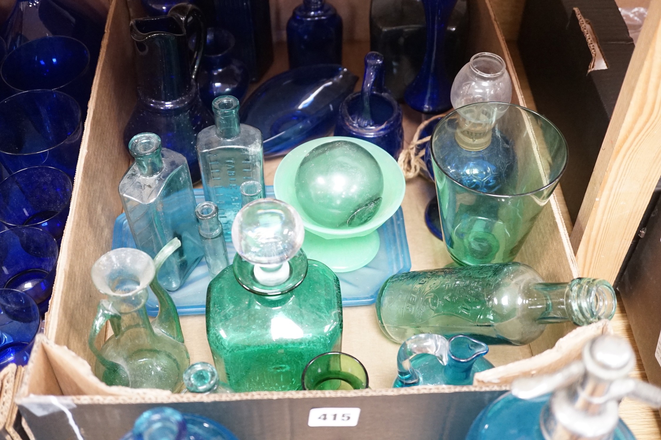 A collection of dark blue, green and turquoise coloured glassware, including three long stemmed glasses